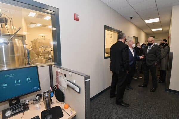 Mr. Kramer, right, giving a tour at the lab in Baltimore where Emergent makes Covid-19 vaccines.