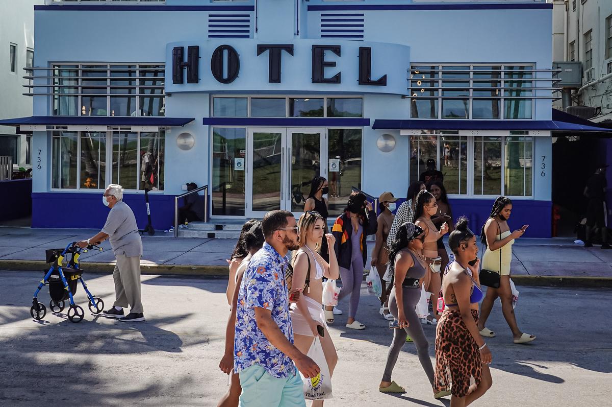 People walk along Ocean Drive during spring break in Miami Beach, Fla., on March 16, 2021. (Joe Raedle/Getty Images)