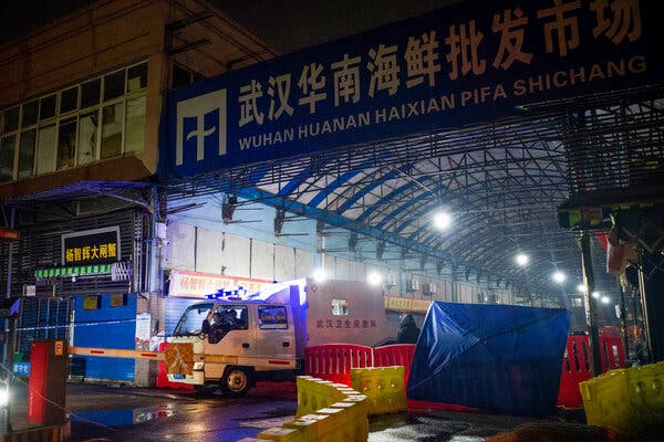 Members of the Wuhan Hygiene Emergency Response Team leaving the closed Huanan Seafood Wholesale Market on Jan. 11, 2020.