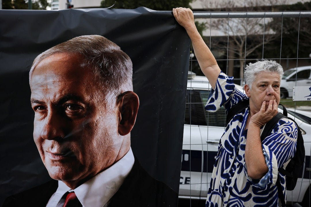 Protest outside the court where Israel's Prime Minister Netanyahu is due to take the stand for the first time in his long-running corruption trial, in Tel Aviv